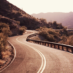 Curved Road along with mountain and forest.